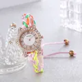 Bohemian women's watch with colorful woven strap and rhinestone bezel on grey background - Pink