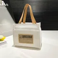 Sac fourre-tout en toile blanche avec anses kaki et étiquette en cuir style rétro - Blanc