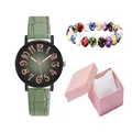 Close-up of women's quartz watch set with green leather strap and colorful beaded bracelet - Wristwatch And Beaded Bracelet And Gift Packaging / Green