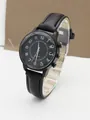 Macro detail of black quartz watch featuring faceted glass edge and white numeric markers - Black Strap Black Dial