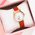 Close-up of rose gold cat-ear watch with red leather strap in a pink velvet gift box - Red Watch Only