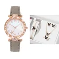 Close-up of women's quartz watch and black butterfly jewelry set in a luxury gift box - Grey Watch + Bracelet