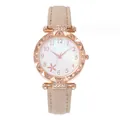 Detail of rose gold scalloped bezel with crystals and beige leather strap on watch - Beige