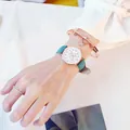 Detail of teal leather watch with heart dial and matching rose gold star bracelets - Green Watch + Bracelet