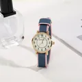 Close-up of a rose gold quartz watch with a blue and pink striped nylon fabric strap - Navy Blue