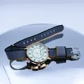 Detailed close-up of a NATO nylon strap watch with gold alloy case and beige dial - Gray