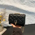 Elegant black quilted crossbody bag featuring a golden chain strap and stylish metal lock - Black