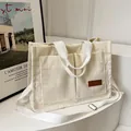 Borsa tote in velluto a coste bianco crema con doppie tasche e tracolla regolabile - Bianco