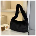Close-up of soft black plush faux fur texture on a stylish women handbag and handle - Black