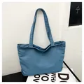 Detailed view of casual blue denim tote bag with long shoulder straps for daily commute - Light Blue