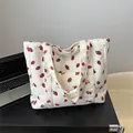 Off-white corduroy tote bag with red strawberry print and front storage pocket - White