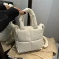 Chic white quilted puffer handbag featuring soft padded handles and square stitching - White