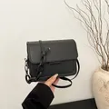 Minimalist black square shoulder bag with chunky chain detail and knotted strap - Black
