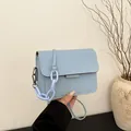 Minimalist light blue square crossbody bag with decorative plastic chain and flap cover - Blue