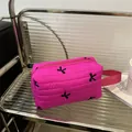 Bright pink quilted cosmetic bag with black flower embroidery and top handle - Rose Red