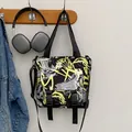 Black nylon messenger bag with neon graffiti print and adjustable cross-body strap - Yellow