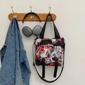 Graffiti nylon messenger bag in black with adjustable strap and buckle closure - Red