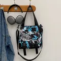Large black nylon crossbody bag with street style graffiti print and adjustable strap - Blue