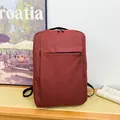 Business laptop backpack in deep burgundy fabric with multiple zippered compartments - Red