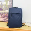 Minimalist navy blue business backpack in durable oxford fabric with hidden front pocket - Blue