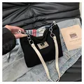 Close-up of black corduroy tote bag featuring bear patch and white leather strap detail - Black