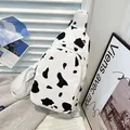 Stylish canvas chest bag with black and white cow print and adjustable strap - White