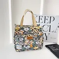 Canvas tote bag featuring cute cartoon cat prints and durable beige strap handles - Green