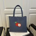 Dark blue canvas tote bag with red apple embroidery and round top handle - Blue