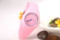 Detailed macro of a pink Geneva quartz watch with silicone strap and floral decor - Pink