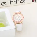 Detail showing rose gold watch with floating rhinestones and white leather strap - White