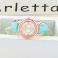 Macro view of light blue leather strap with crocodile texture and rose gold watch case - Cyan
