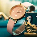 Detail of rose gold butterfly embossed watch dial with sparkling crystal indexes - Pink