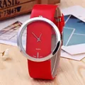 Fashionable women's red leather watch with hollow quartz dial on a wooden table - Red
