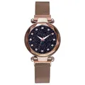 Close-up of starry sky dial with crystal markers and faceted glass on rose gold watch - Watch / Coffee