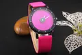Macro shot of shimmering starry dial with pink glitter and rose red leather watch strap - Rose Red