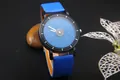 Detail view of starry sky watch dial with blue and orange dual-tone leather strap - Blue