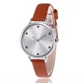 Detailed view of women's silver quartz watch with red hearts and leather strap - Brown