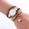 Detail of dragonfly wrap watch with rhinestone accents and rose gold hardware - Tan