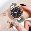Close-up of star dial quartz watch with green leather strap and heart bracelet on wrist - Watch And Bracelet / Green