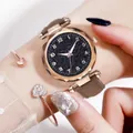 Detail view of starry sky watch with faceted glass and heart bracelets on wrist - Watch And Bracelet / Brown