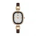 Detailed macro view of rose gold oval watch case with sparkling crystal bezel and Tadi logo - Watch / Brown