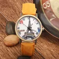 Vintage bronze quartz watch with Eiffel Tower dial and yellow strap on rustic wood - Yellow