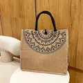 Natural jute tote bag with black geometric print and woven handles in earthy tones - Style 2