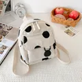Mini corduroy backpack featuring black polka dots and dual zippers in off-white - White