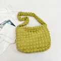 Detailed macro view of the lime green ruched cloud bag showing soft bubble texture fabric - Green