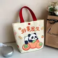 Cute panda and persimmon print canvas bucket bag with red handles and snap closure - Peanut Trio