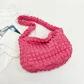 Detailed close-up of rose pink pleated bubble fabric on a stylish shoulder bag - Rose Pink