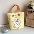 Bright yellow canvas bucket bag with cute cartoon white duck illustration and orange handles - Happy Duck