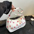 Minimalist white canvas shoulder bag featuring all-over red cherry print and gold zipper - Cherry Style