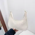 Minimalist creamy white nylon crescent shoulder bag with smooth curved silhouette - White